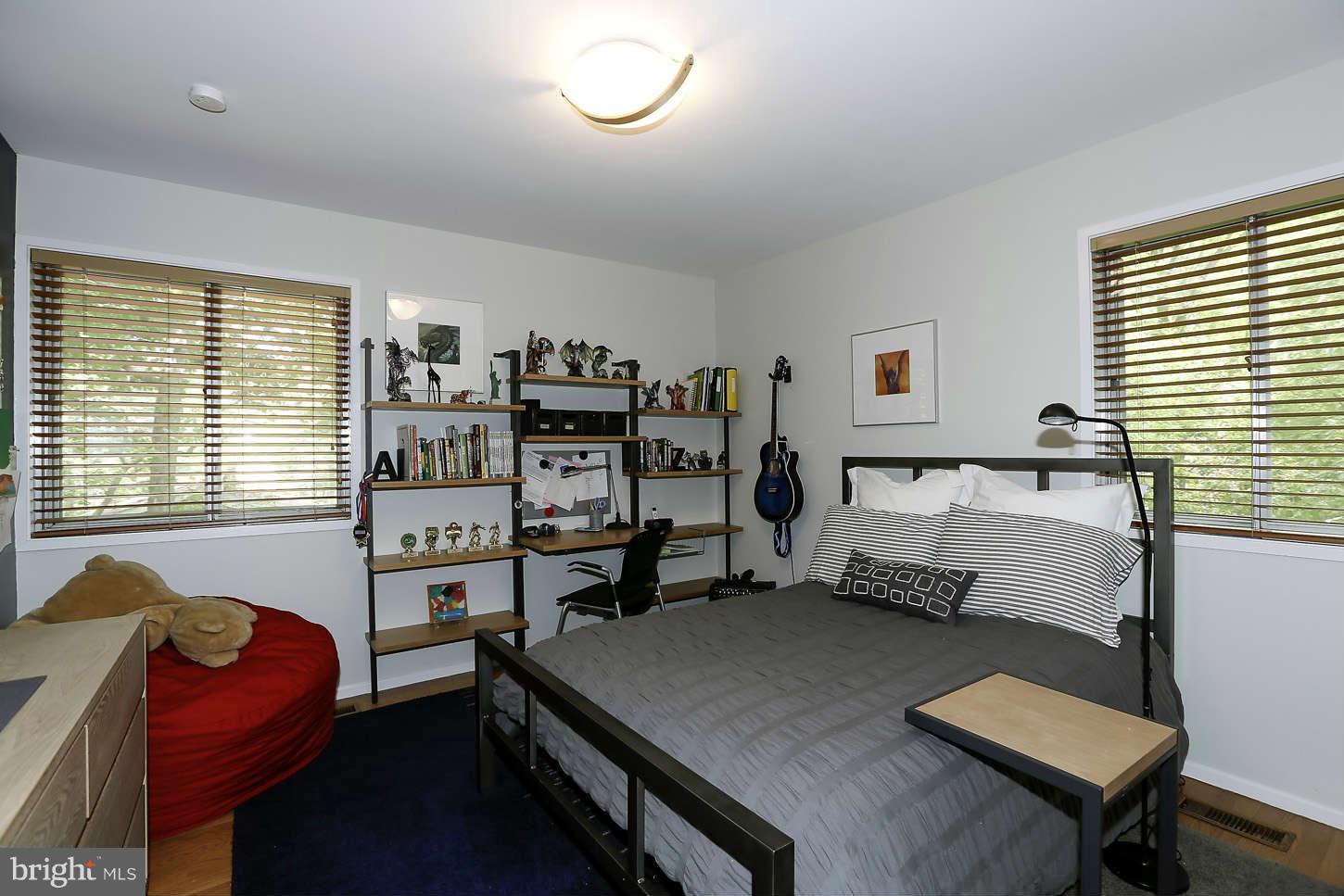 7503 Hamilton Spring Road Bethesda, MD 20817 - Photo 14 of 30 a bedroom with a bed and a desk