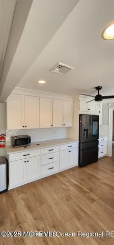 a kitchen with granite countertop a refrigerator sink and stove