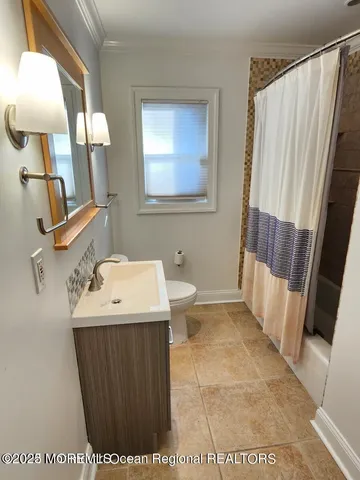 a bathroom with a sink a toilet and mirror