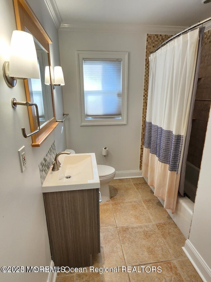47 Poplar Avenue West Long Branch, NJ 07764 - Photo 18 of 21 a bathroom with a sink a toilet and mirror