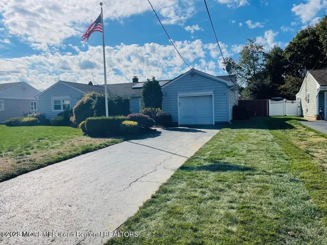a view of a house with a backyard