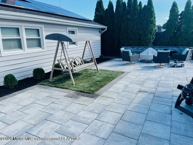 a backyard of a house with table and chairs