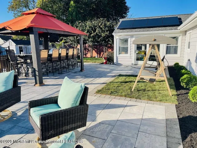 a view of a house with backyard porch and sitting area