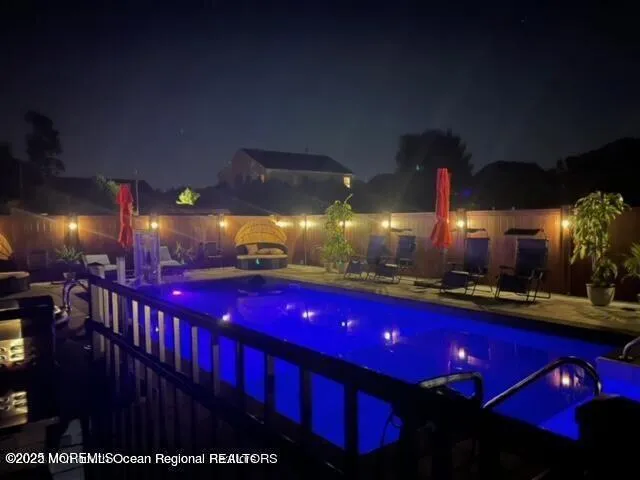 a view of swimming pool with tables and chairs