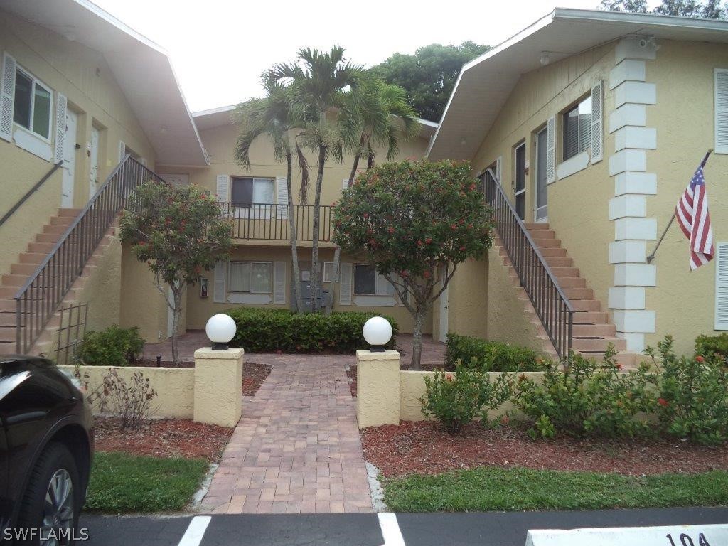 8061 Country Road, Unit 102 Fort Myers, FL 33919 - Photo 1 of 1 a front view of a house with garden