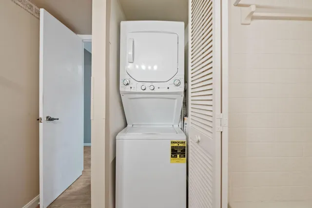 a view of a room with wooden floor and windows