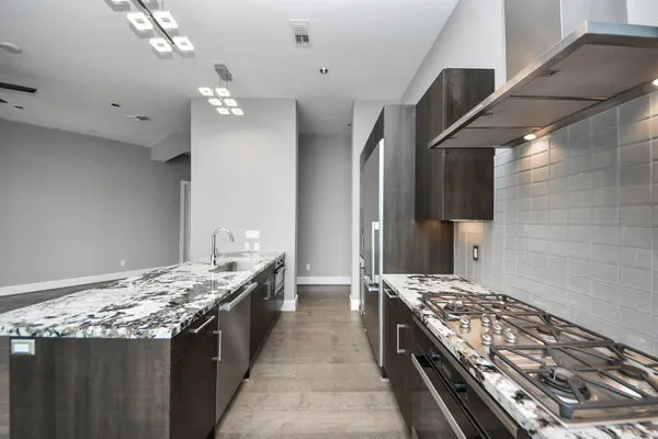 a stove top oven sitting inside of a kitchen