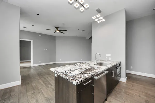 a view of an empty room with a ceiling fan