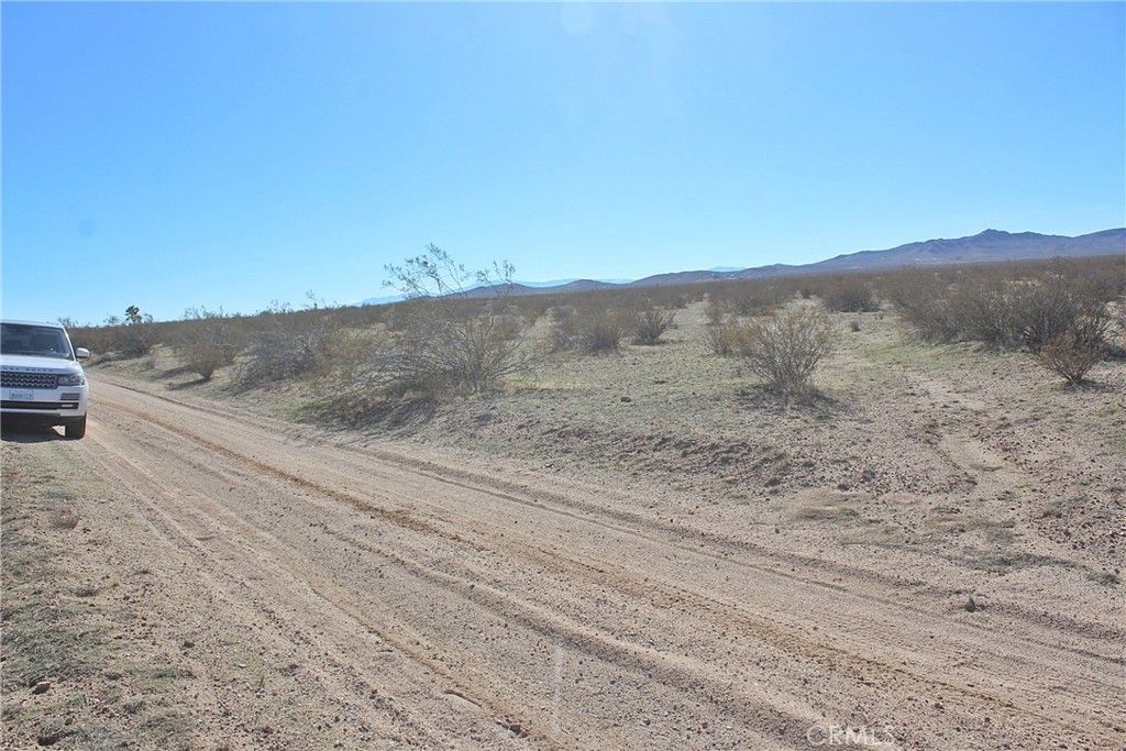 112 Highway 395 Hines, OR 97738 - Photo 1 of 8 a view of a dry yard with mountains in the background