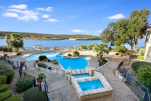 a view of a lake with couches and city view