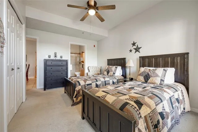 a bathroom with a granite countertop sink a toilet and shower