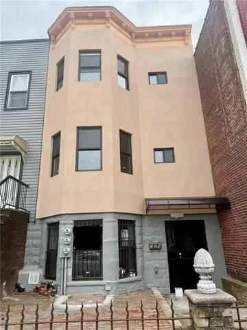 a front view of a house with barbeque area