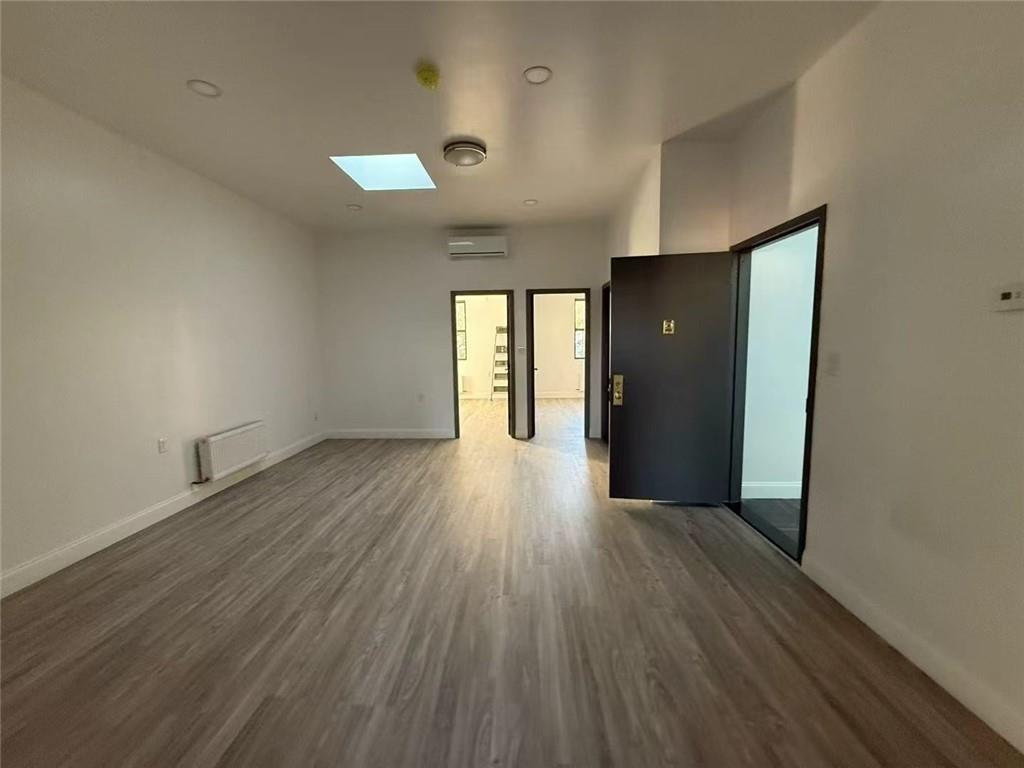 320 Bay Ridge Parkway Brooklyn, NY 11209 - Photo 3 of 10 wooden floor in an empty room with a window
