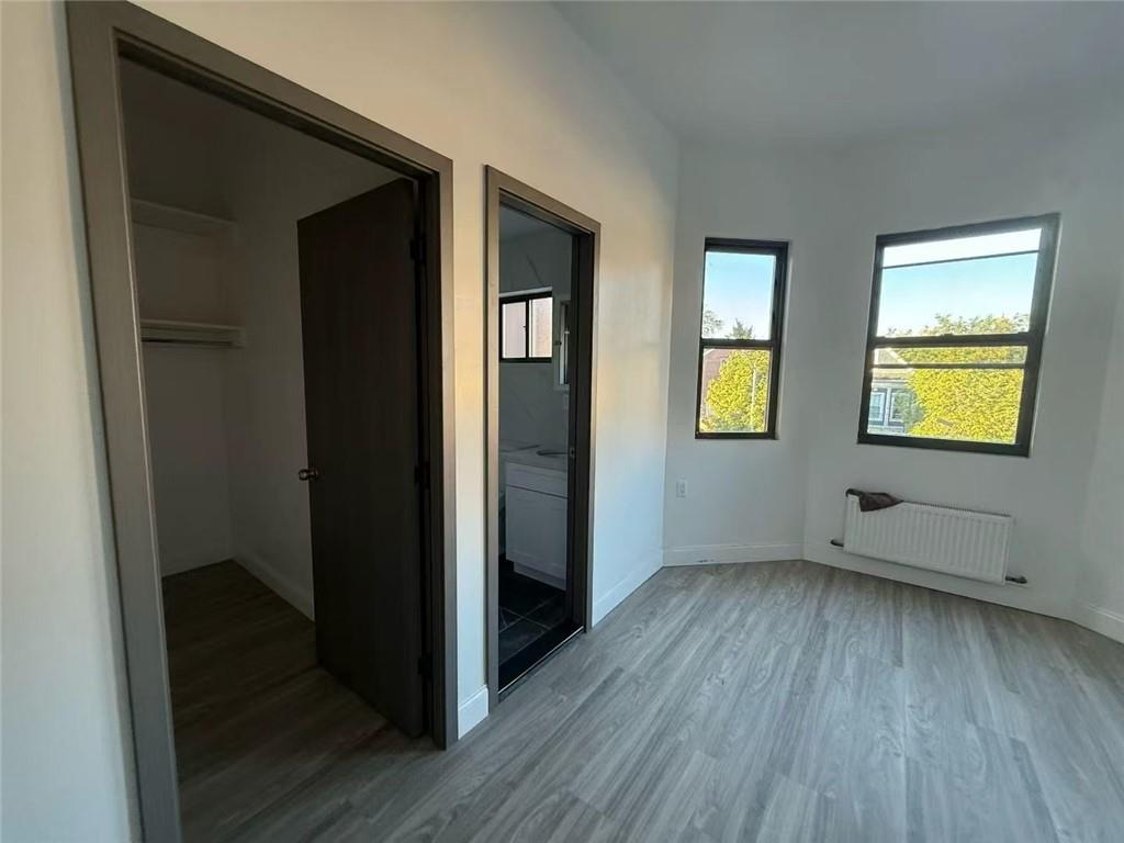 320 Bay Ridge Parkway Brooklyn, NY 11209 - Photo 5 of 10 an empty room with wooden floor and windows