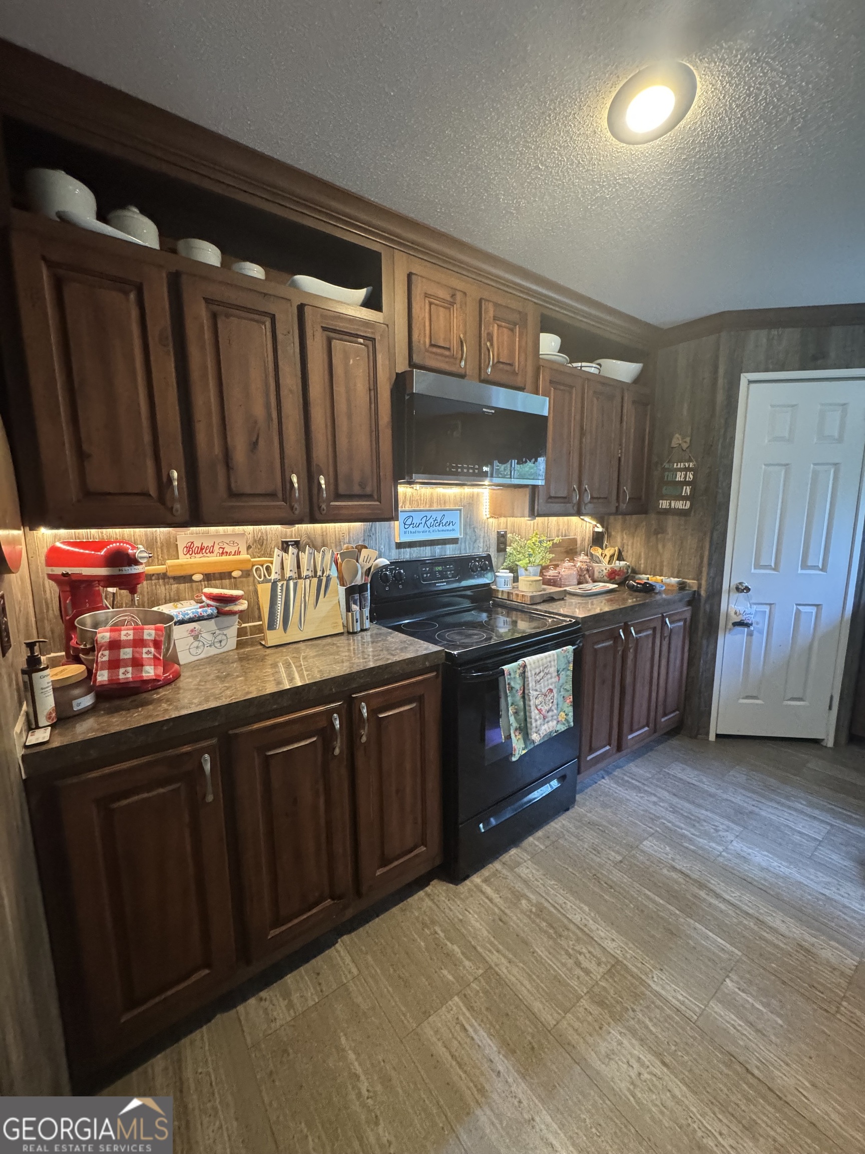92 Graham Lane Claxton, GA 30417 - Photo 14 of 20 a kitchen with stainless steel appliances granite countertop a stove a sink dishwasher and a microwave oven