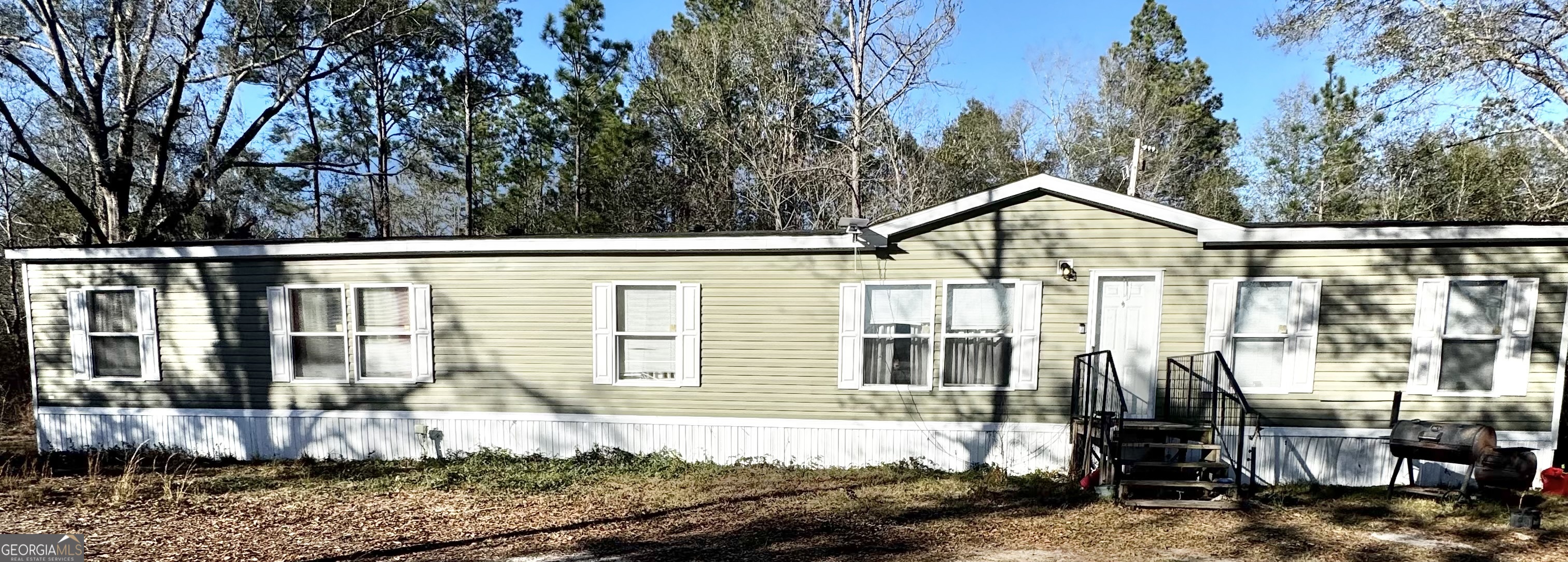 92 Graham Lane Claxton, GA 30417 - Photo 2 of 20 a front view of a house with a yard