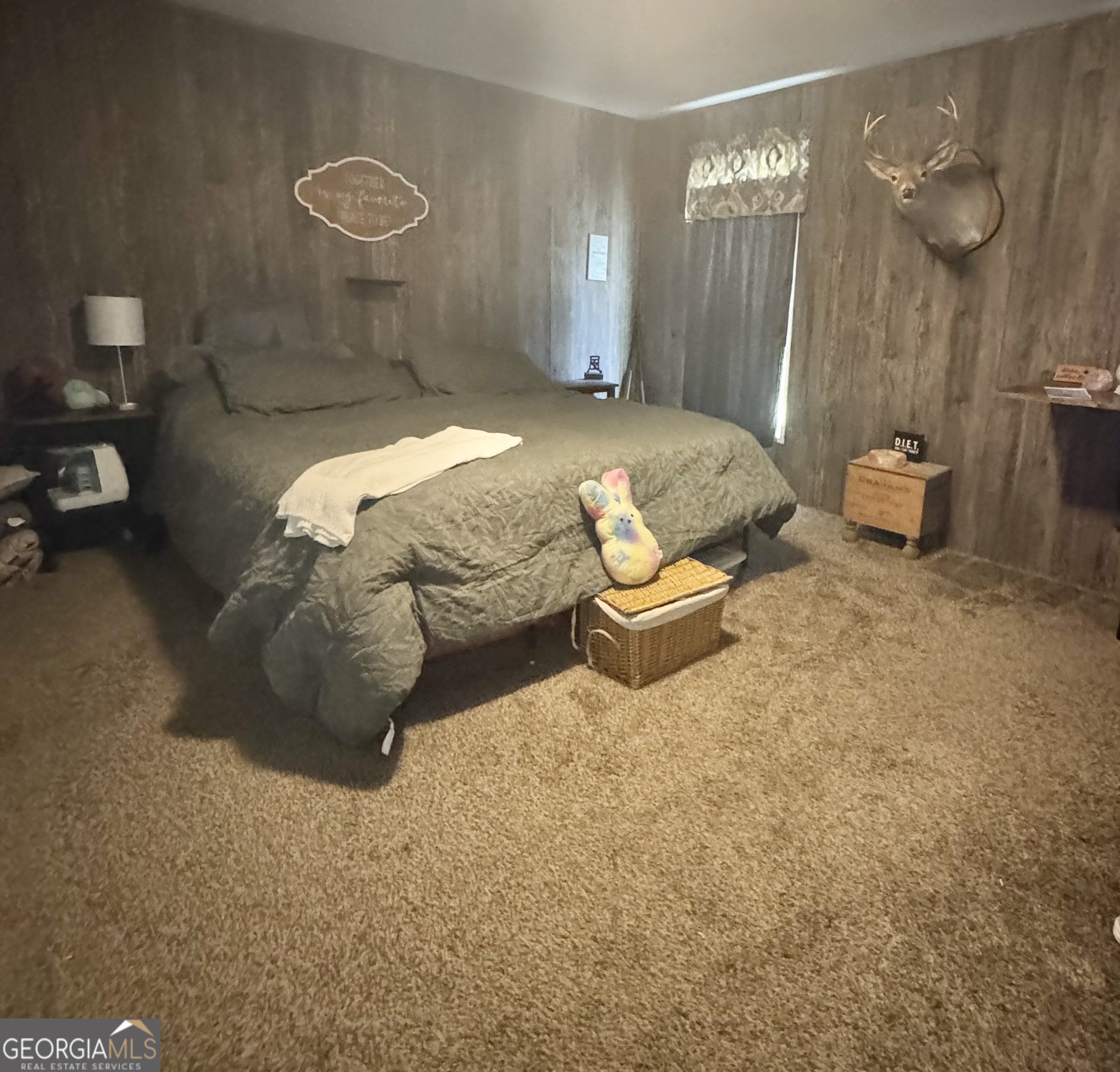 92 Graham Lane Claxton, GA 30417 - Photo 6 of 18 a bedroom with a bed and a chandelier