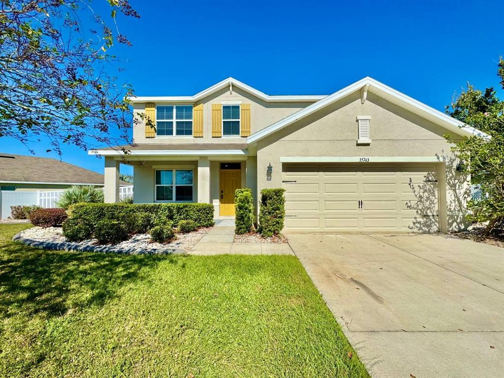 35743 Hillbrook Avenue Zephyrhills, FL 33541 - Photo 1 of 44 a front view of a house with yard