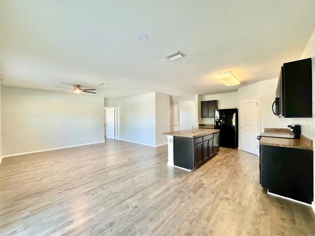 35743 Hillbrook Avenue Zephyrhills, FL 33541 - Photo 11 of 44 a large kitchen with cabinets and stainless steel appliances