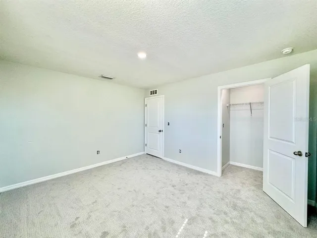 a bathroom with a granite countertop sink a toilet a mirror a bathtub and shower
