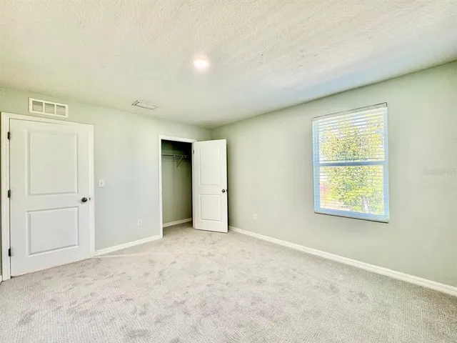 an empty room with a empty space and windows