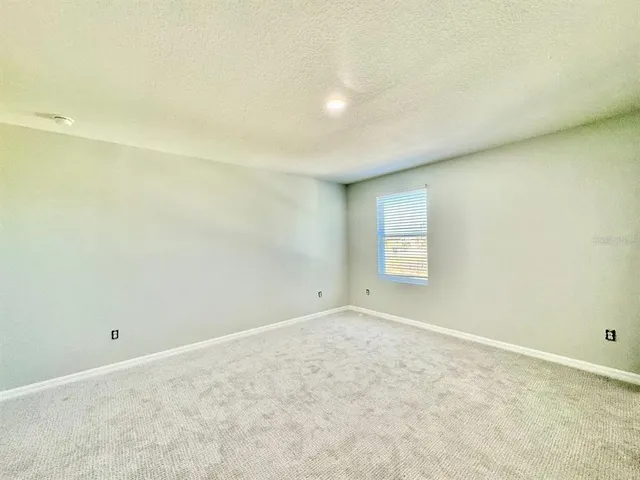 a view of a garden with a building in the background