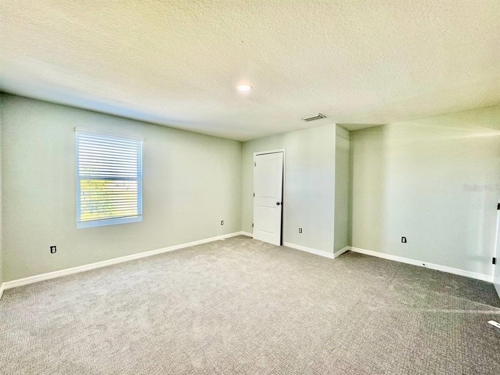 35743 Hillbrook Avenue Zephyrhills, FL 33541 - Photo 36 of 44 an empty room with a empty space and windows