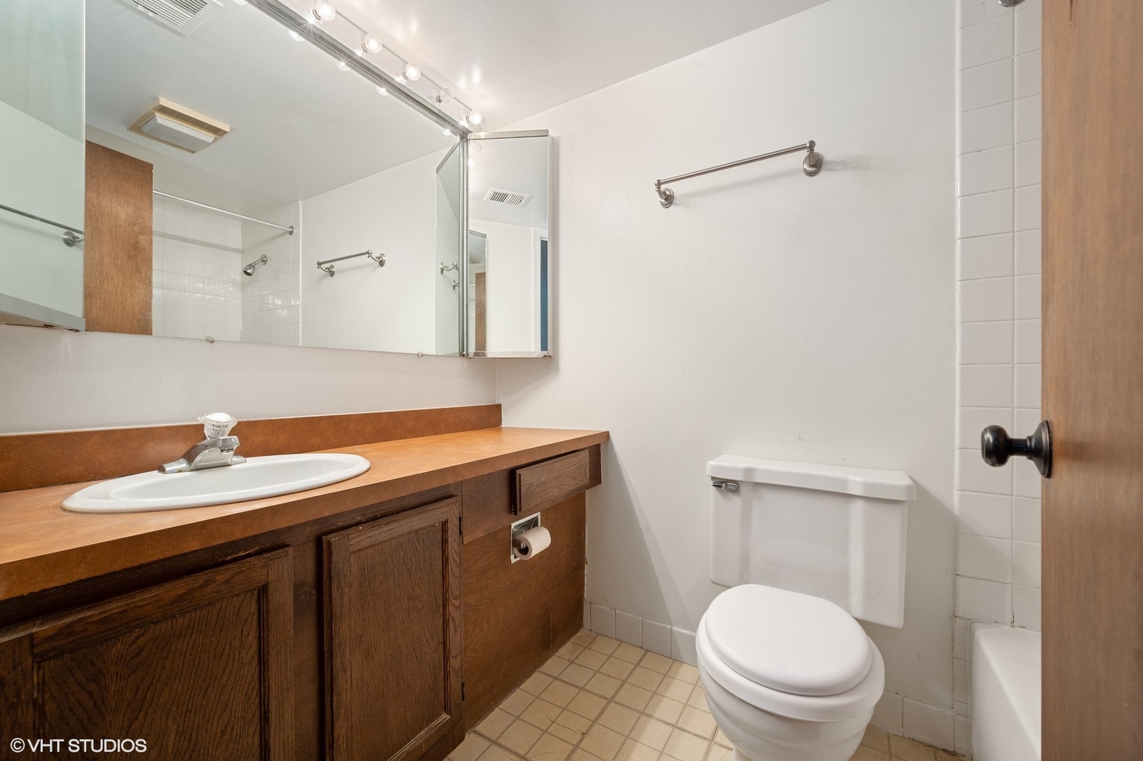 651 West Sheridan Road, Unit 2C Chicago, IL 60613 - Photo 12 of 16 a bathroom with a granite countertop sink toilet and shower