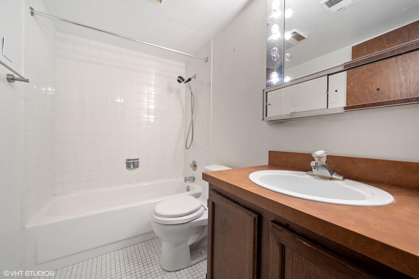 651 West Sheridan Road, Unit 2C Chicago, IL 60613 - Photo 9 of 16 a bathroom with a sink a toilet a mirror and shower
