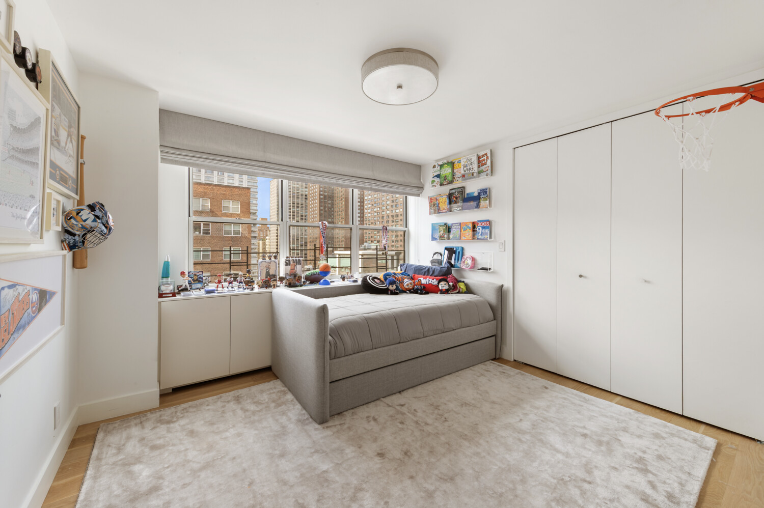 300 East 71st Street, Unit 16HJ Manhattan, NY 10021 - Photo 4 of 8 a living room with furniture and a window