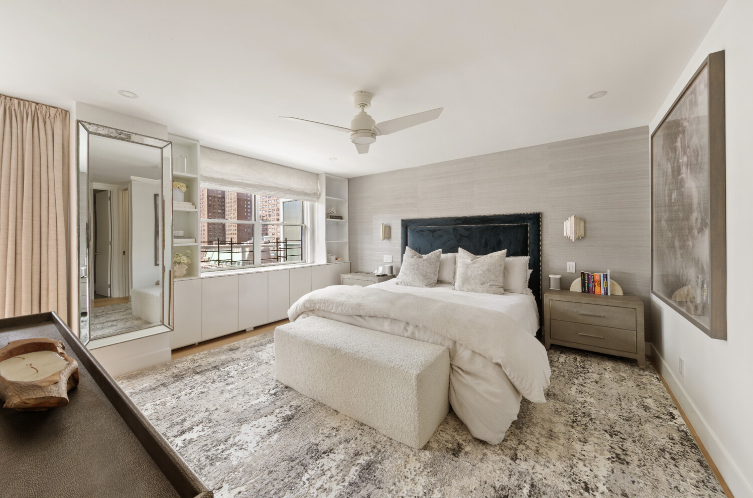300 East 71st Street, Unit 16HJ Manhattan, NY 10021 - Photo 6 of 8 a spacious bedroom with a bed a couch and dresser