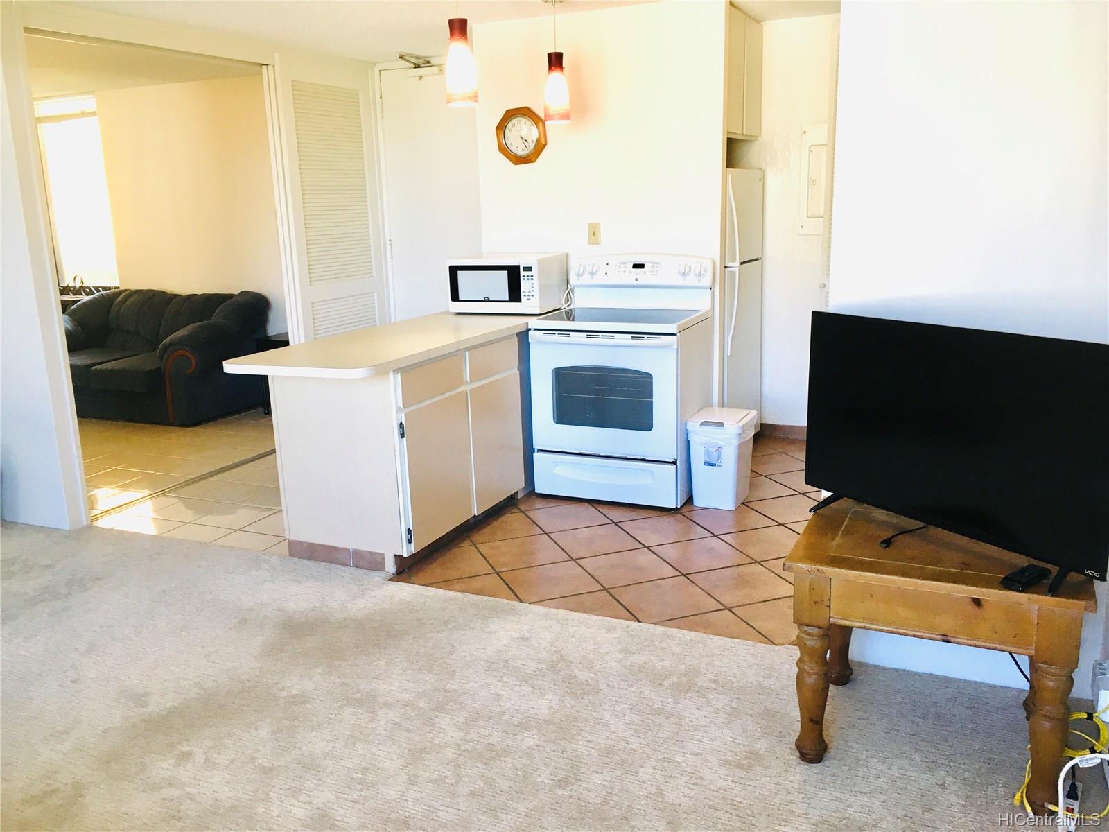 a living room with washer and a flat screen tv