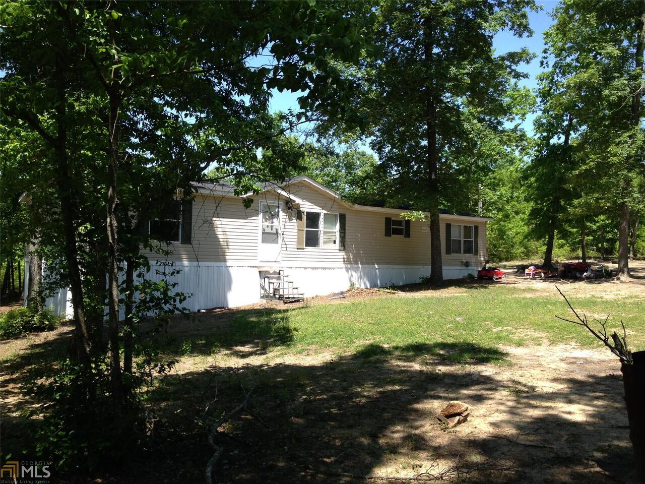 1288 Underwood Road Sparta, GA 31087 - Photo 1 of 1 a front view of a house with a yard garage and outdoor seating