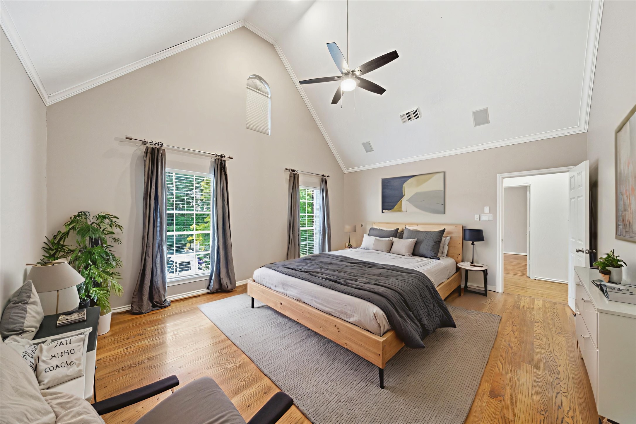 1736 Colquitt Street, Unit A Houston, TX 77098 - Photo 27 of 45 Soaring vaulted ceiling and multiple windows frame this expansive primary suite, blending comfort with a sense of refined openness. - Virtually Staged -