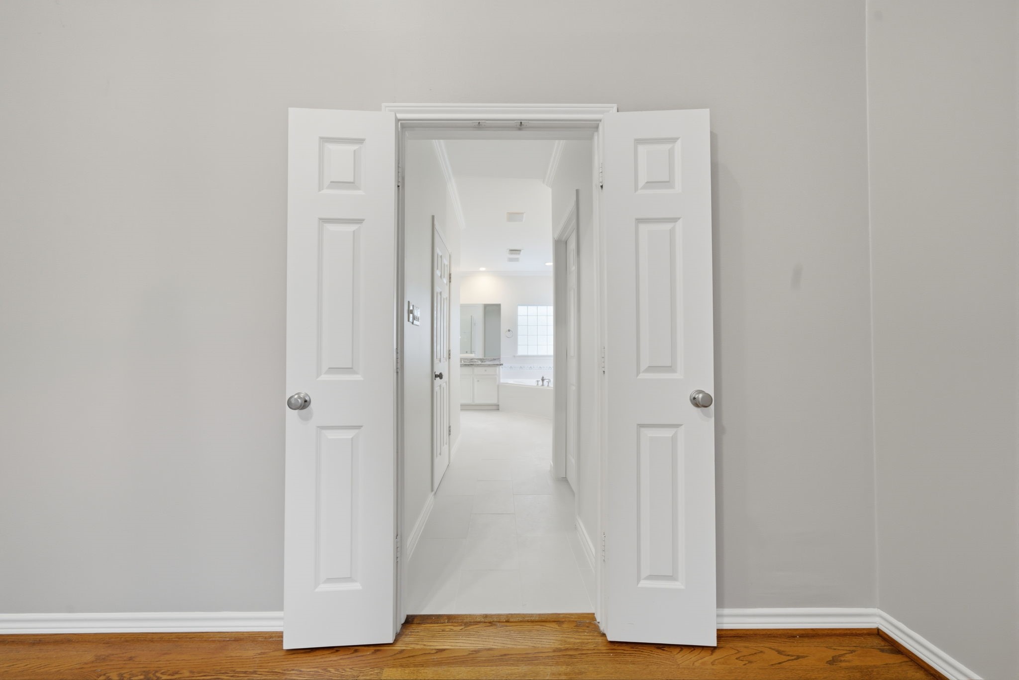 1736 Colquitt Street, Unit A Houston, TX 77098 - Photo 32 of 45 The primary bedroom continues through classic french doors into your spacious, light-filled primary ensuite.