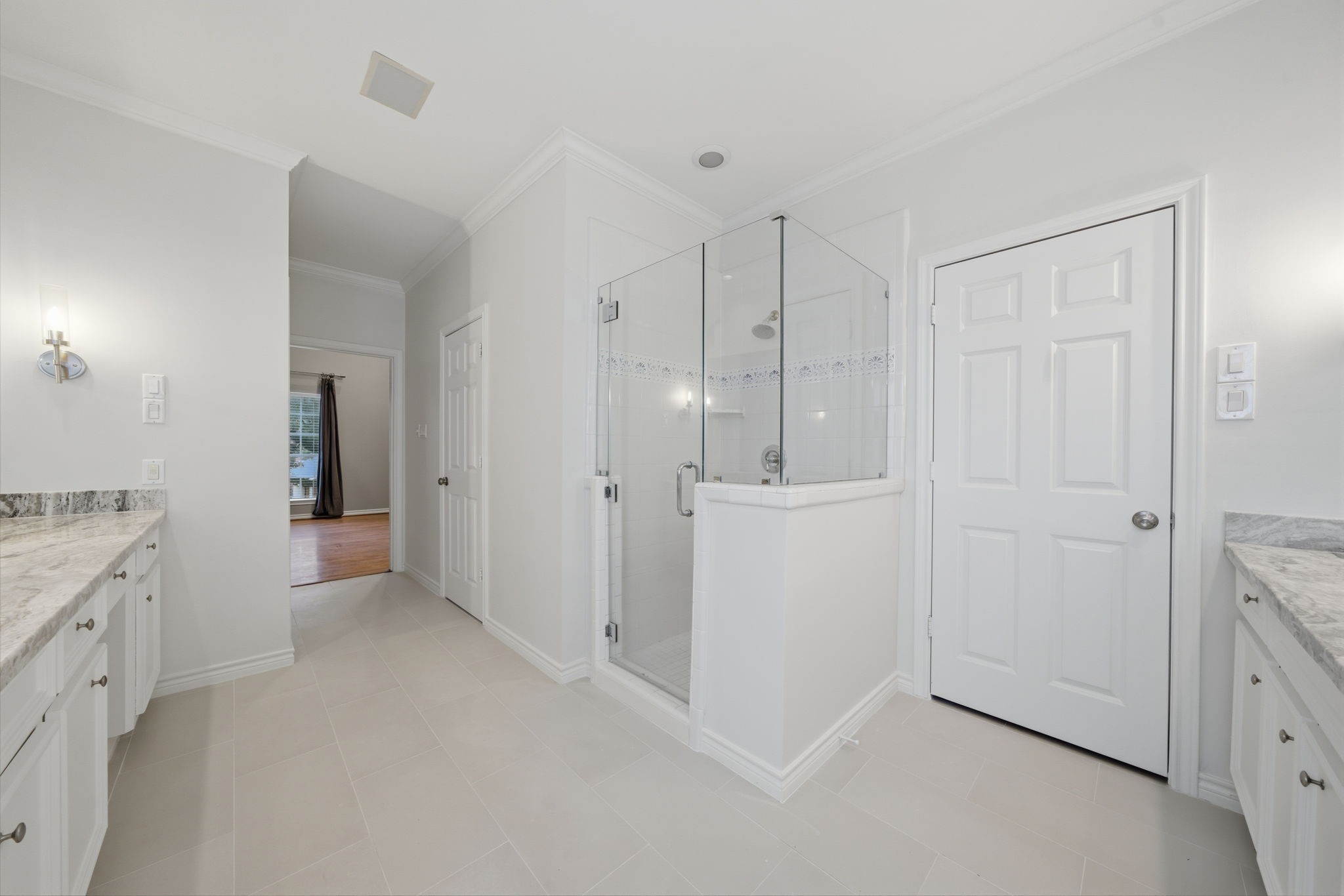 1736 Colquitt Street, Unit A Houston, TX 77098 - Photo 35 of 45 This perspective reveals the updated glass shower and the thoughtfully placed doors to two individual walk-in closets.