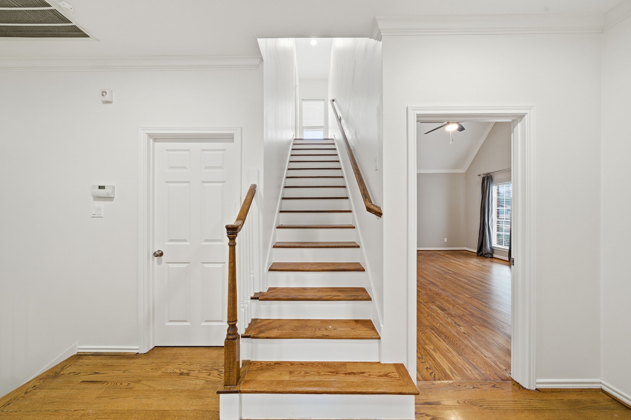 1736 Colquitt Street, Unit A Houston, TX 77098 - Photo 37 of 45 This upper-level hallway connects directly to the laundry room and primary suite, with stairs leading to a large, versatile third-floor flex space.