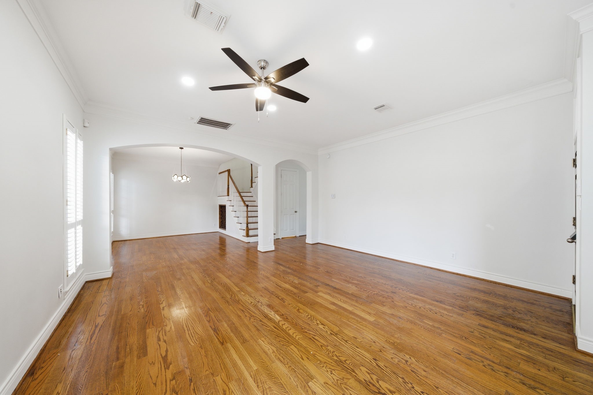 1736 Colquitt Street, Unit A Houston, TX 77098 - Photo 5 of 45 Wide sightlines and warm hardwood floors connect the living and dining spaces, emphasizing the home’s generous and rare first-floor layout.