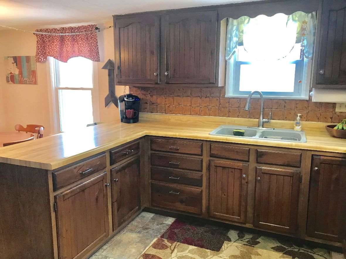 216 South Washington Street Byron, IL 61010 - Photo 13 of 25 a kitchen with a sink cabinets and window