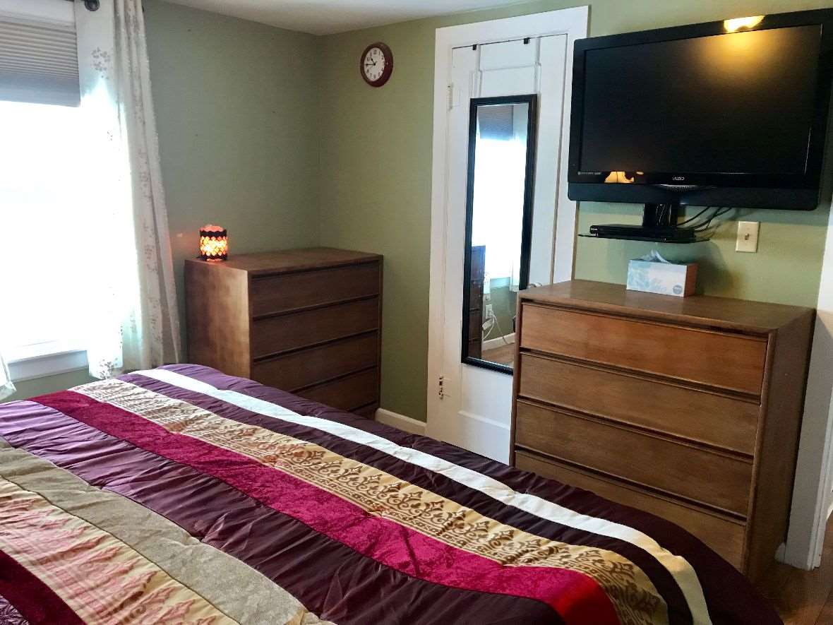 216 South Washington Street Byron, IL 61010 - Photo 17 of 25 a bedroom with a bed and a flat screen tv