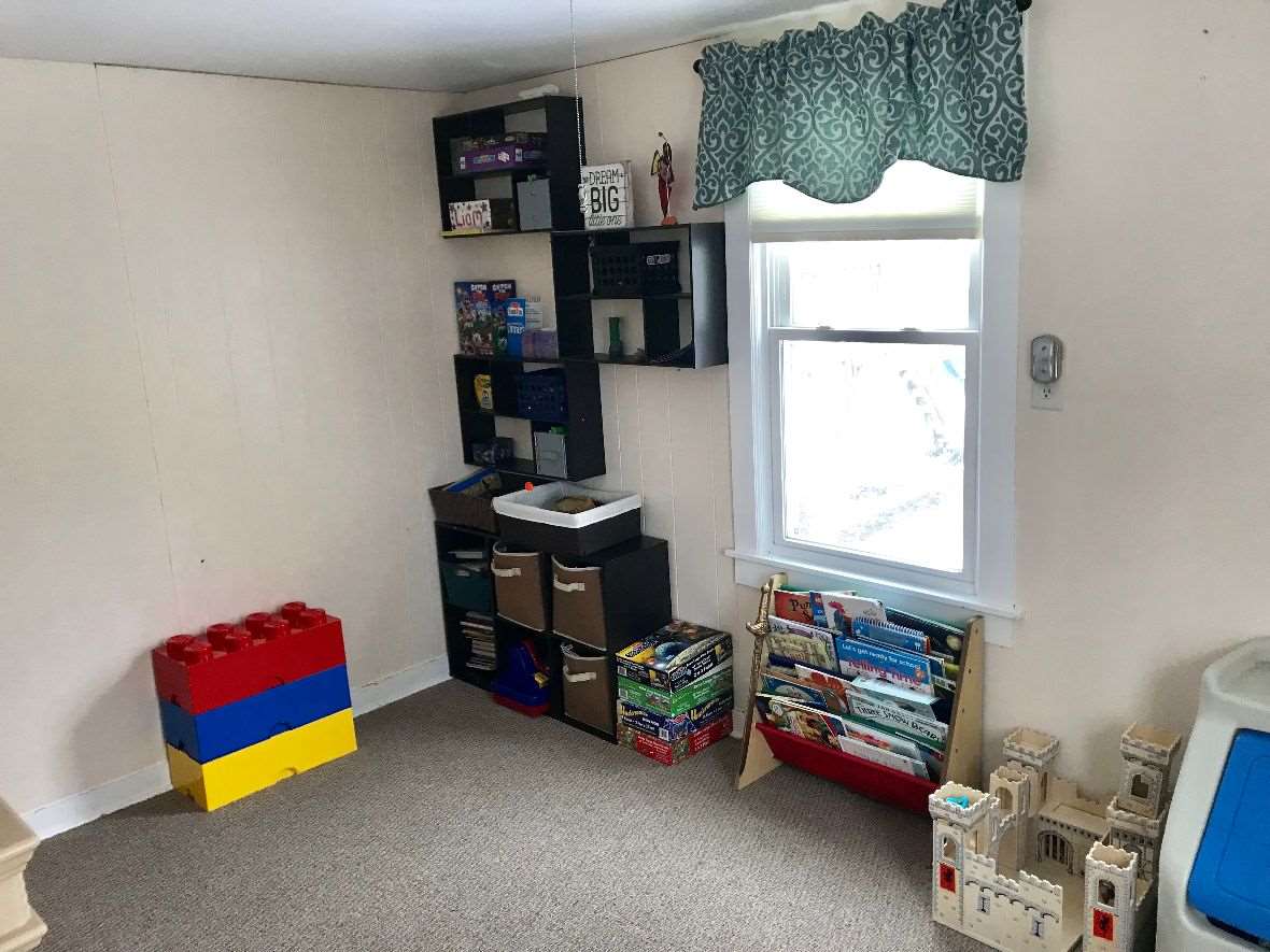 216 South Washington Street Byron, IL 61010 - Photo 19 of 25 a room with furniture a rug toys and a window