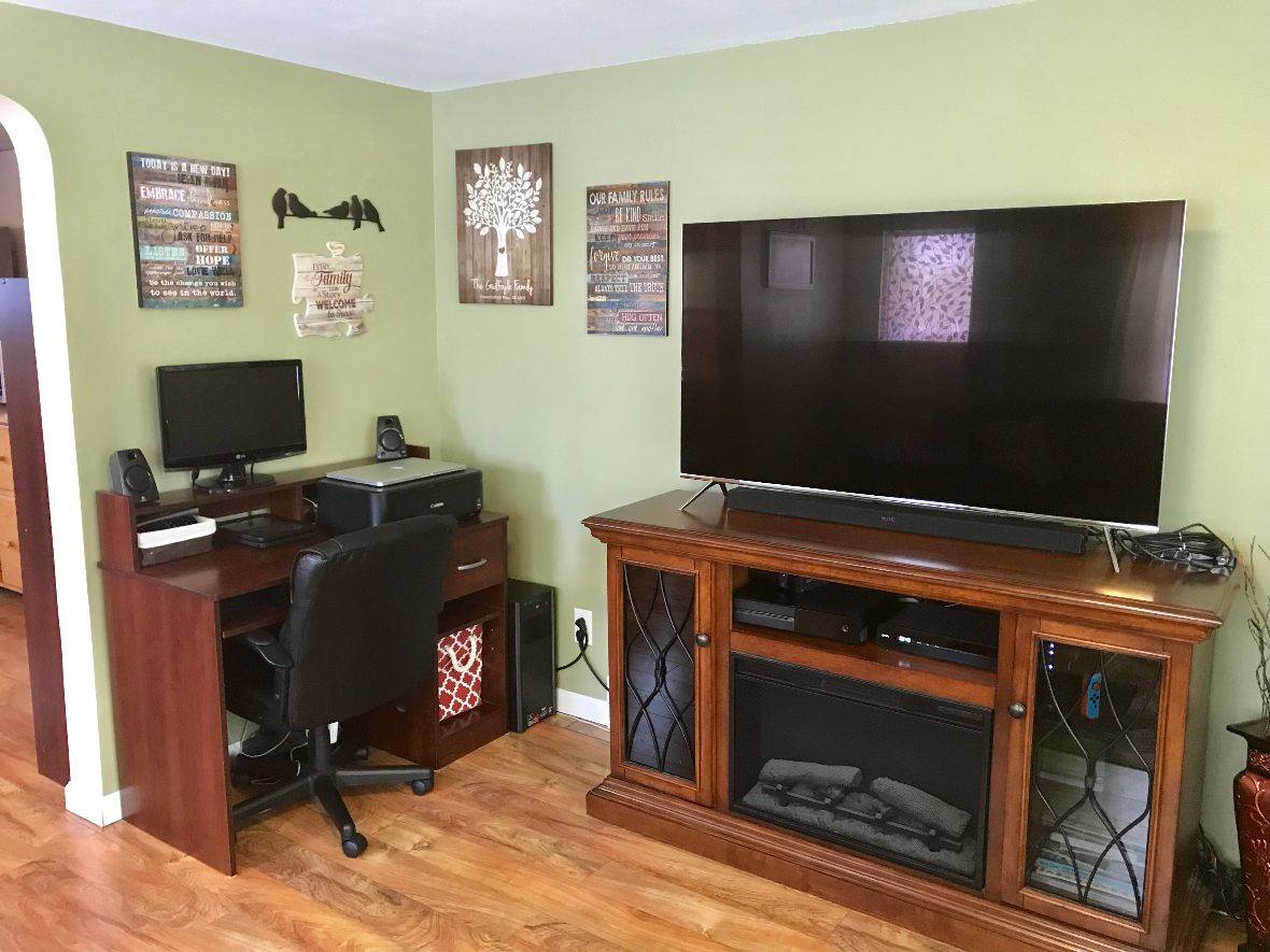 216 South Washington Street Byron, IL 61010 - Photo 7 of 25 a room with furniture and a flat screen tv