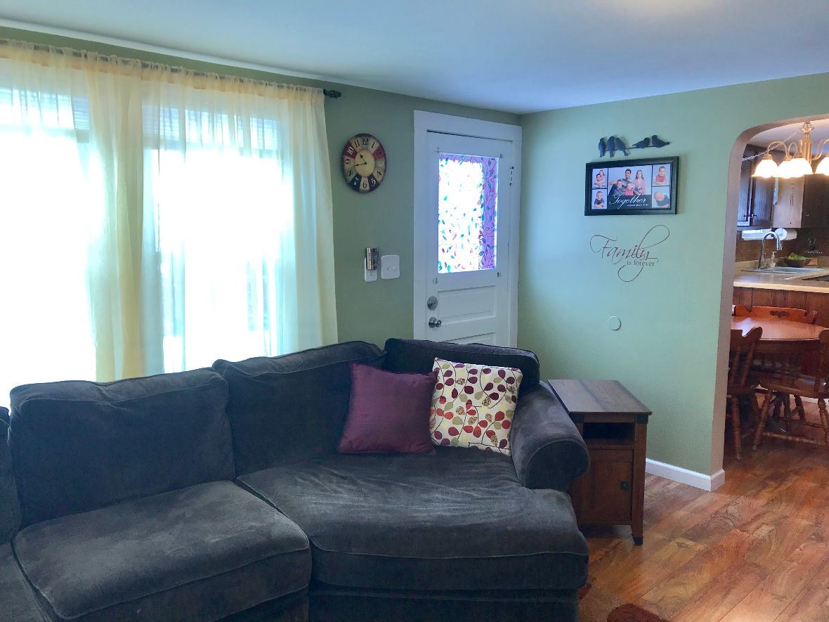 216 South Washington Street Byron, IL 61010 - Photo 8 of 25 a living room with furniture and a window