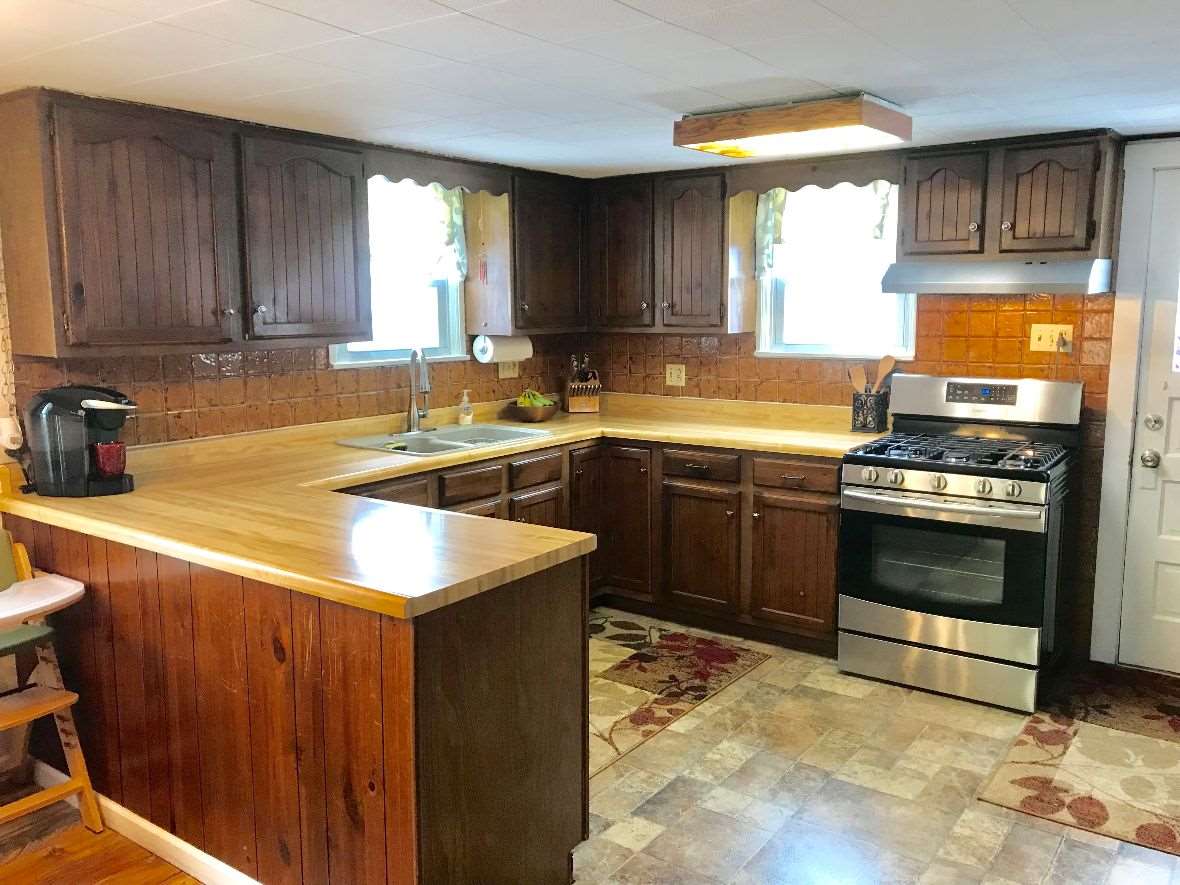 216 South Washington Street Byron, IL 61010 - Photo 10 of 25 a kitchen with a sink stove top oven and cabinets