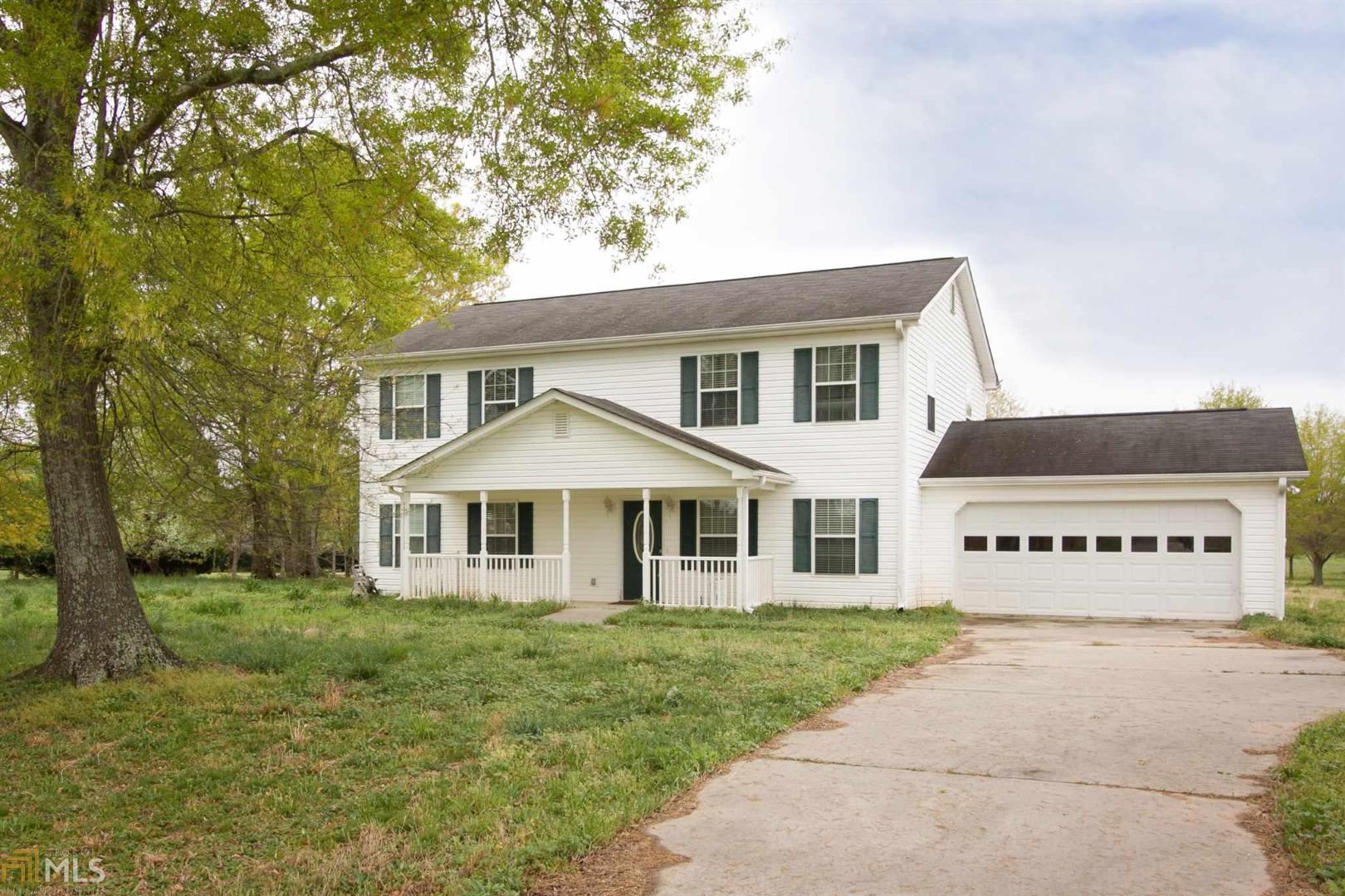 2069 Wayne Meadows Road, Unit 64 Good Hope, GA 30641 - Photo 1 of 1 a front view of a house with a yard and trees