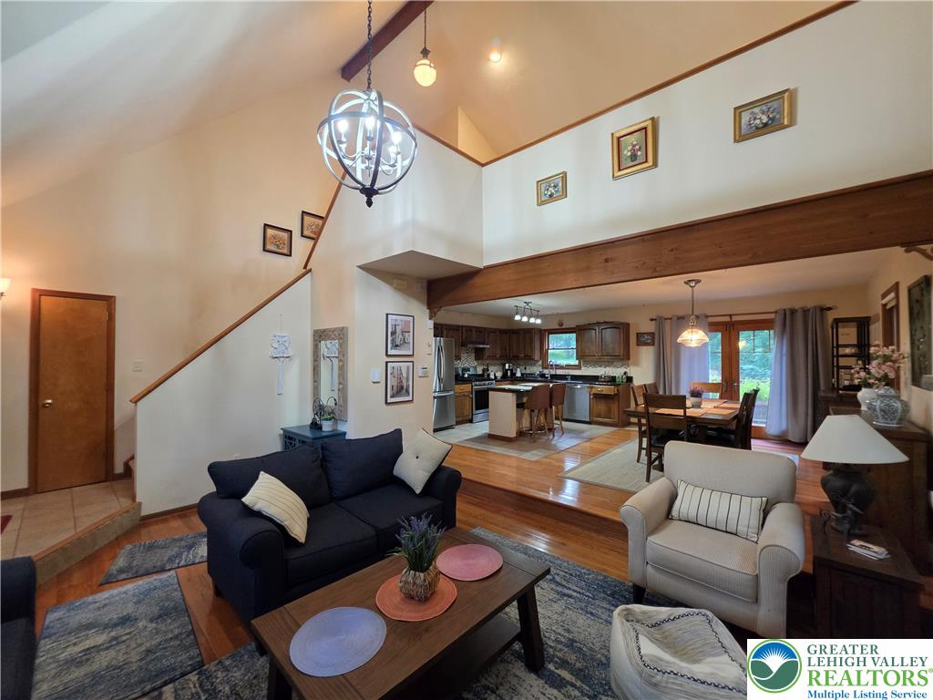 211 Murphy Circle Bushkill, PA 18324 - Photo 5 of 28 An inviting open-concept living space features soaring ceilings and beautiful hardwood flooring.