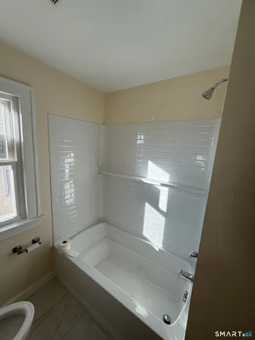 a bathroom with a tub and shower