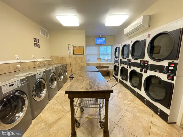 a utility room with sink dryer and washer