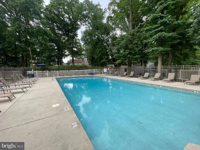 a swimming pool with outdoor seating and yard