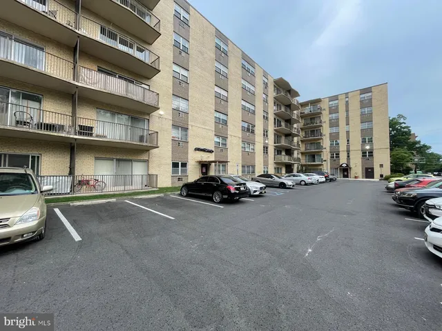 a view of a street that has couple of cars parked on road